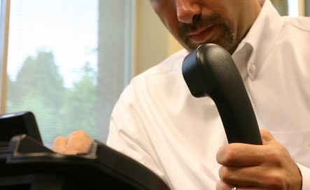 Image of man picking up the telephone
